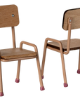 Two small Maileg Table and Chairs by Maileg, featuring beech wood frames with light brown seats and beige metal legs tipped in pink, are placed side by side—one forward, one angled backward—in this charming set.