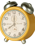 Yellow vintage-style metal alarm clock with silver bells by Maileg, white face, black numbers set to 8:00.