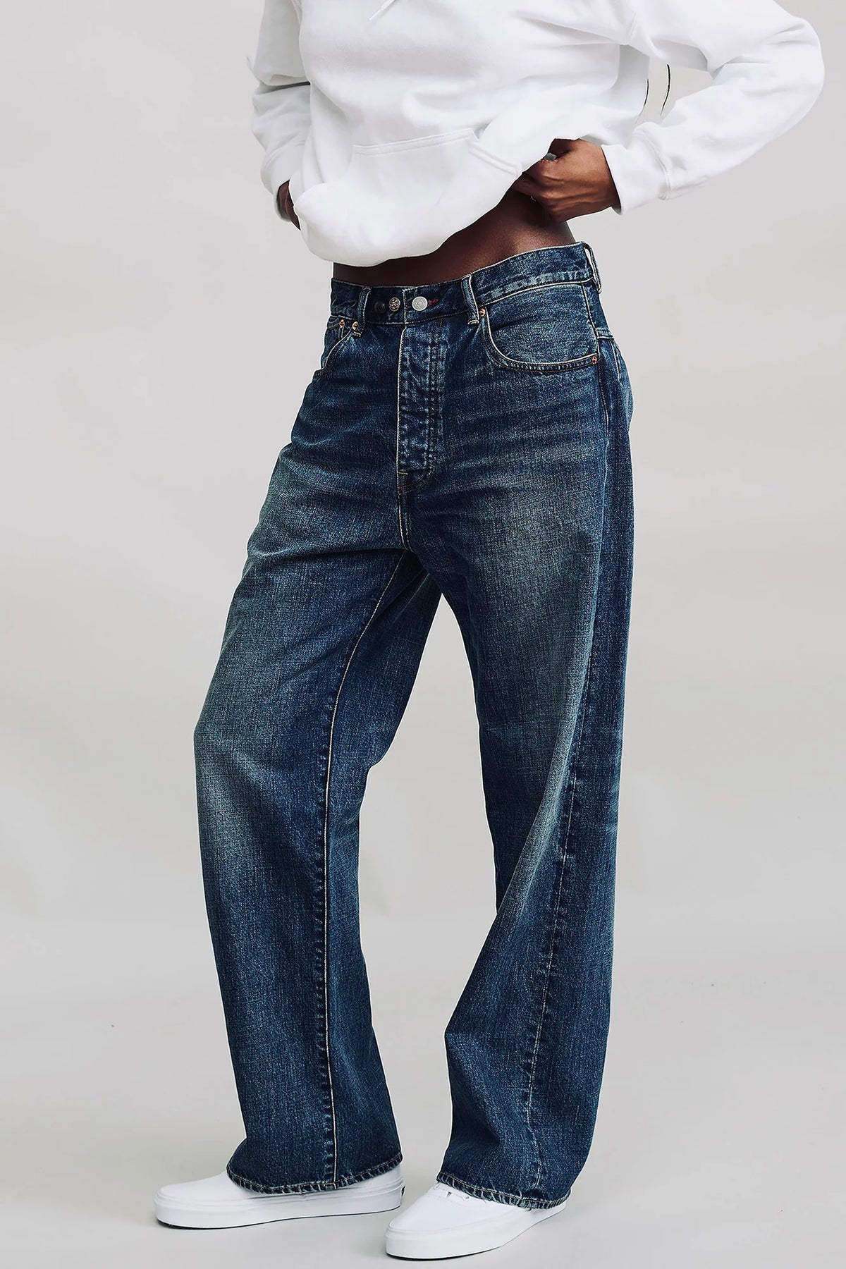 Denimist ALLFIT Jean styled with a white hoodie and sneakers, modern casual look against a plain backdrop.