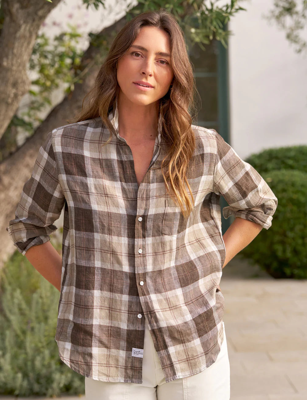 Frank & Eileen relaxed fit cotton plaid shirt in outdoor garden setting with greenery and building in the background.