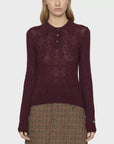 Burgundy argyle polo sweater with a brown plaid skirt by Sea New York, styled against a white background.