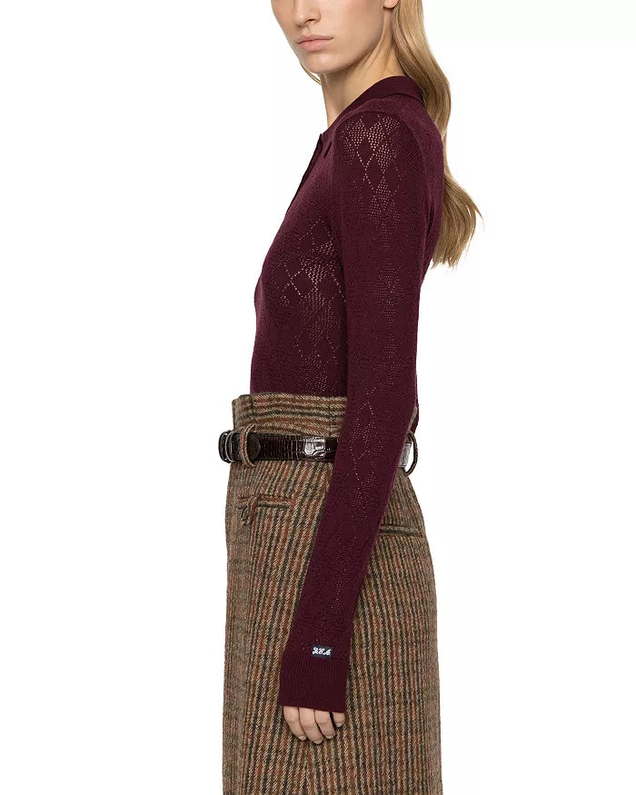 Maroon argyle polo sweater by Sea New York styled with a brown high-waisted skirt, shown in profile.