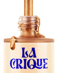 A bottle of Faire Natural Bronzing Serum Sun Radiance, with metallic gold liquid pouring from the open neck and bold blue lettering, delivers a natural glow for luminous, sun-kissed skin.