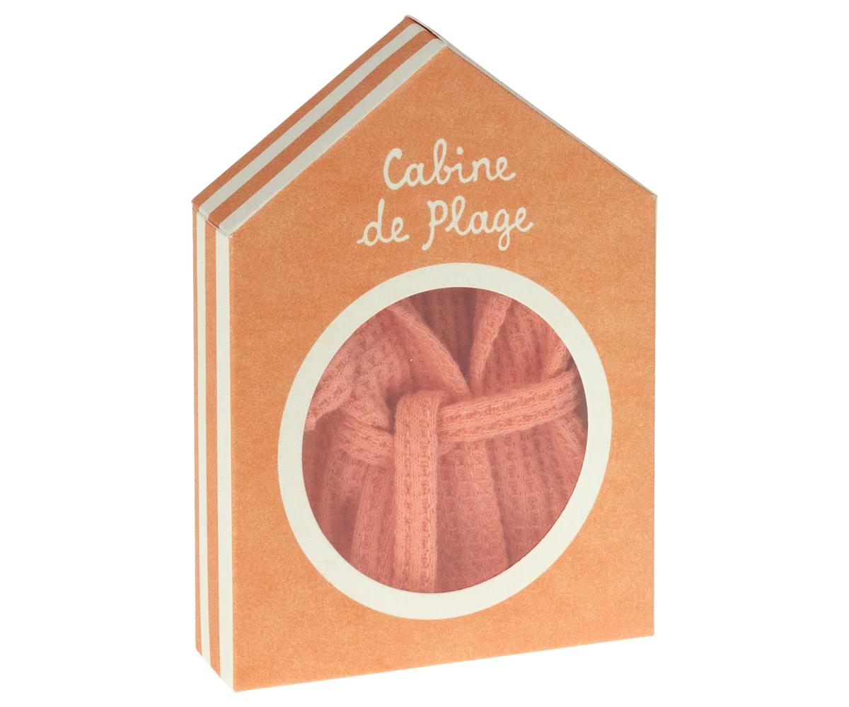 Folded coral Maileg bathrobe visible through window in the Peach Cabine de Plage house box by Maileg.