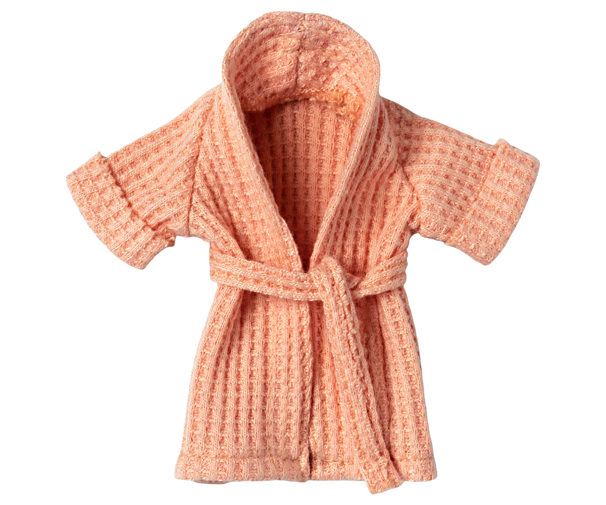 Coral pink textured bathrobe with tie belt by Maileg on a white background, cozy kids clothing.