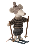 The Maileg Winter Mouse by Maileg is a plush Christmas mouse dressed in a knitted hat, striped sweater, and pants, standing on blue skis and holding wooden ski poles.