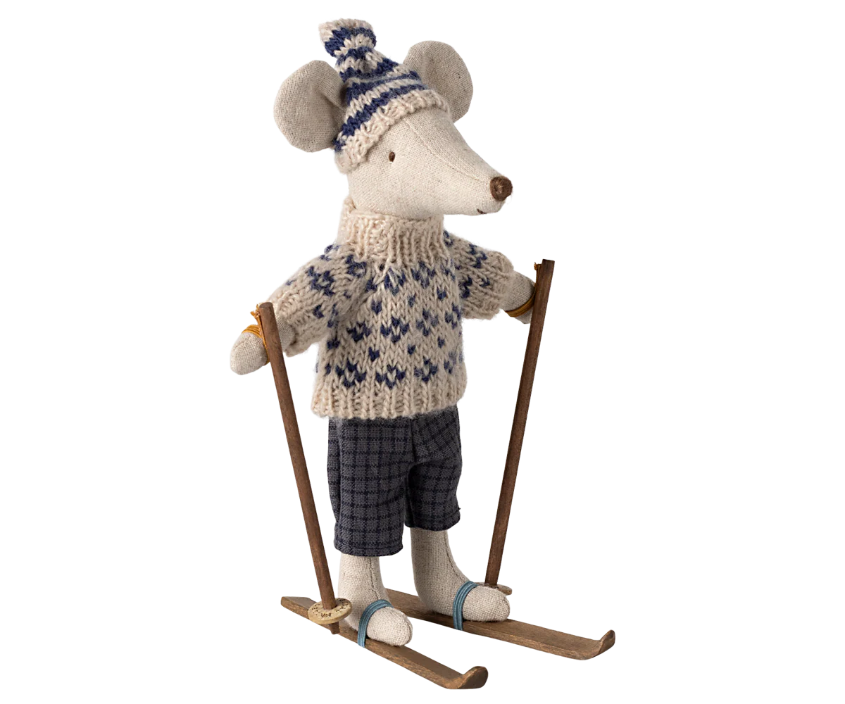 The Maileg Winter Mouse by Maileg features a Christmas mouse in a knitted hat, sweater, plaid pants, and blue boots standing on wooden skis—an adorable addition to any winter mice collection.