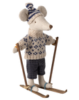 The Maileg Winter Mouse by Maileg features a Christmas mouse in a knitted hat, sweater, plaid pants, and blue boots standing on wooden skis—an adorable addition to any winter mice collection.