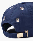 Navy baseball cap with embroidered cat faces and gold buckle, Faire Cool Cats collection at Bungalow Furniture.