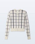 The White + Warren Cashmere Windowpane Cardigan features a cream color with black windowpane intarsia knit, straight fit, button front, and ribbed cuffs and hem, shown laid flat on a light background.