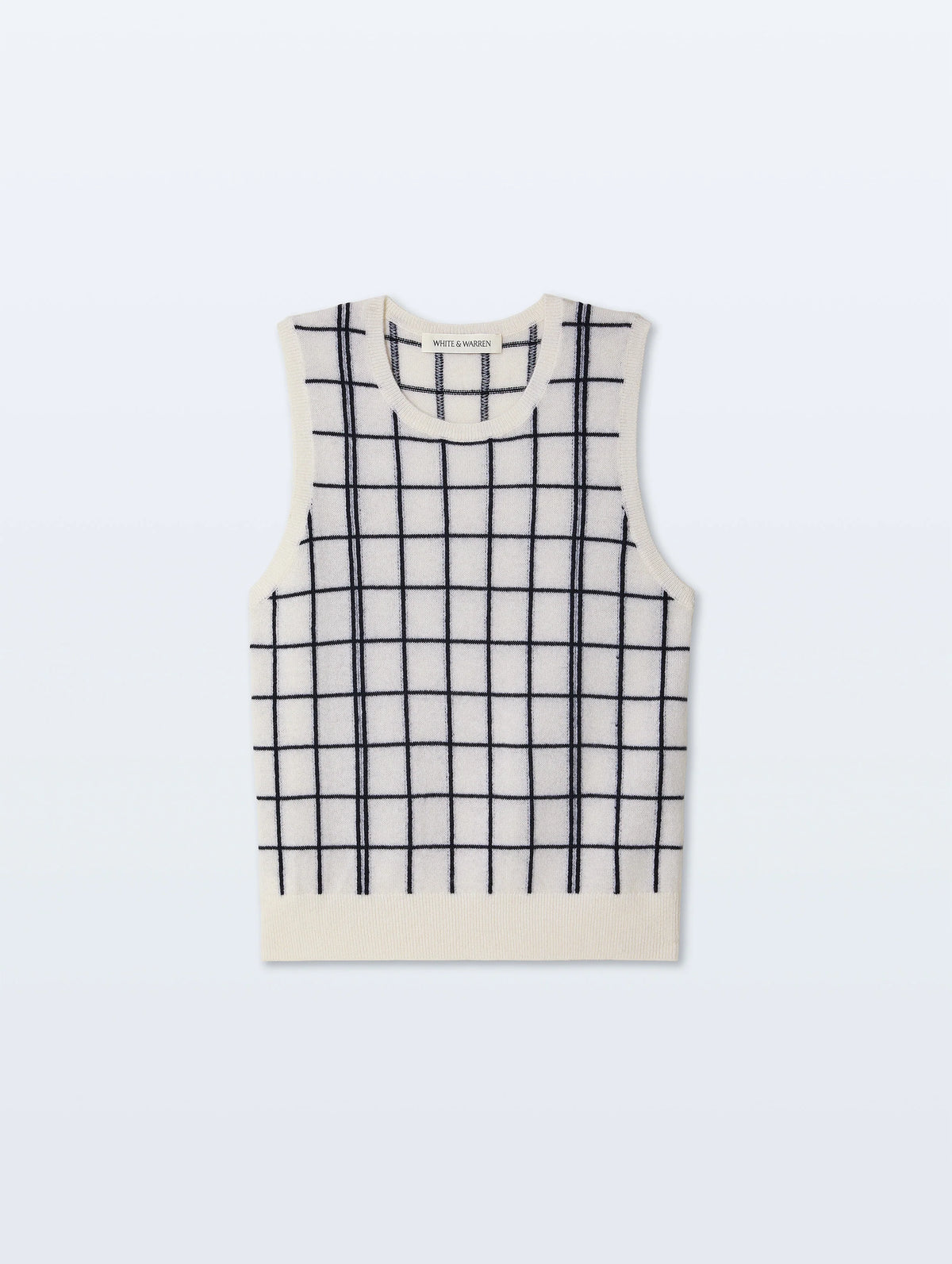The White + Warren Cashmere Windowpane Vest is a sleeveless, cream piece featuring a black windowpane pattern, shown on a light background.