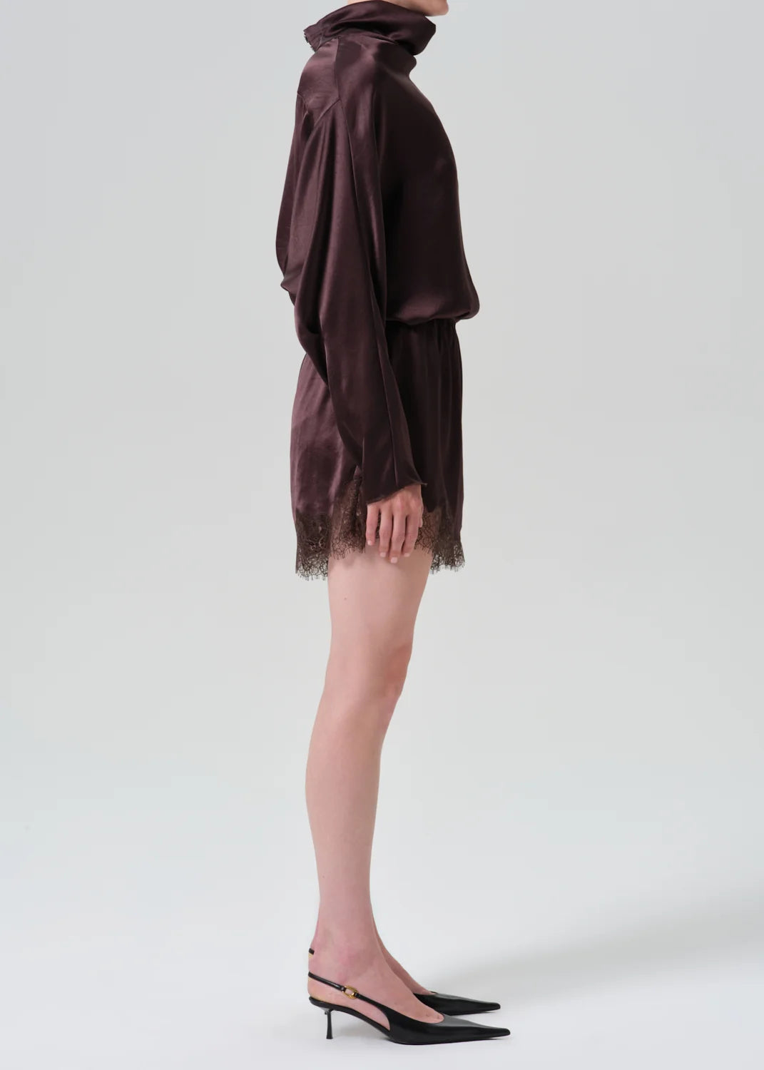 Lace Trimmed Tap Shorts by Citizens Of Humanity styled with black heels, shown in side profile against a plain backdrop.