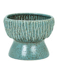 The Norlin Bowl by The Import Collection is a blue-green ceramic planter featuring a raised leaf-like pattern, speckled finish, wide round opening, and flared narrow base—ideal for tabletops or stylish decor accents.