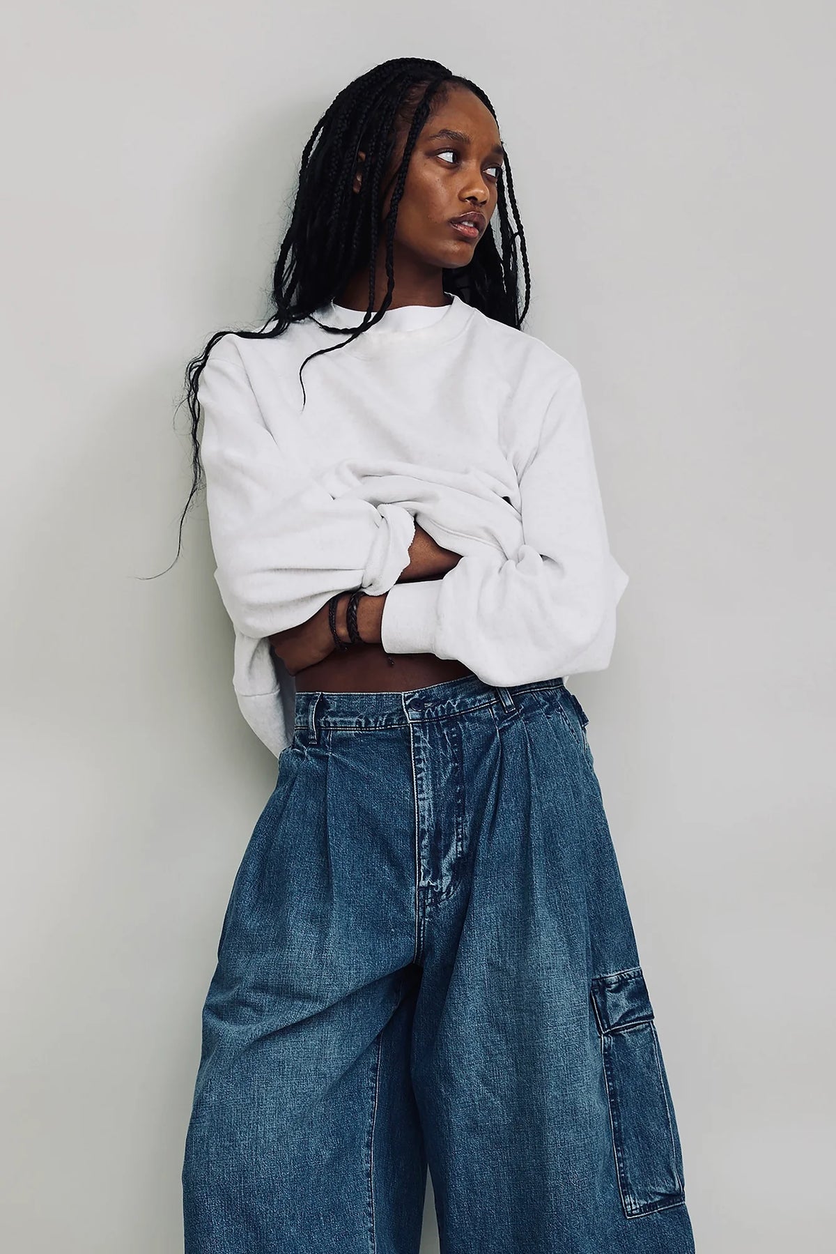 Denimist AINSLEY triple pleat cargo shorts in denim blue, shown outdoors styled with a casual look.