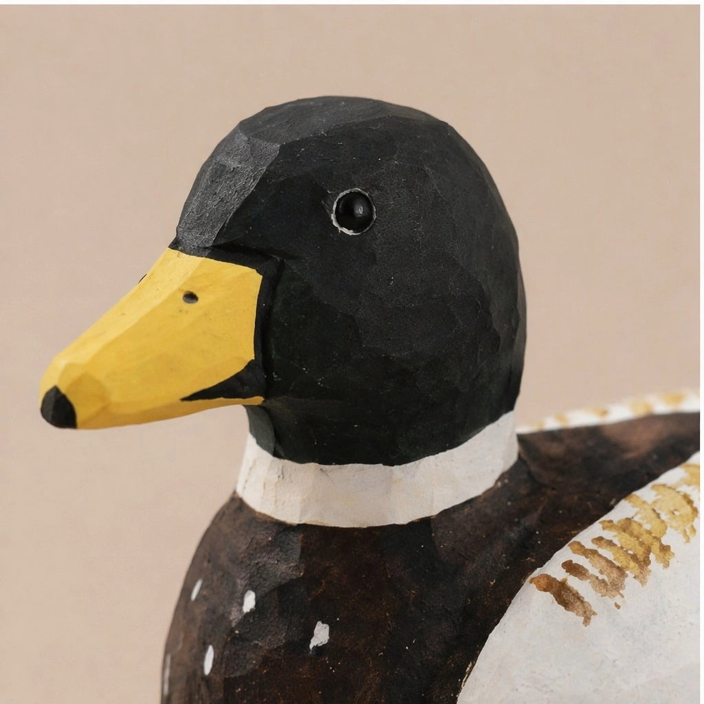 Hand-painted carved basswood duck with yellow beak and black head by Faire, rustic decor accent for home.