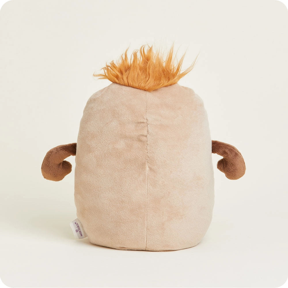 The Faire Potato Warmies is a soft, beige microwavable plush toy featuring small brown arms and orange spiky hair on top, shown from the back against a plain light background.