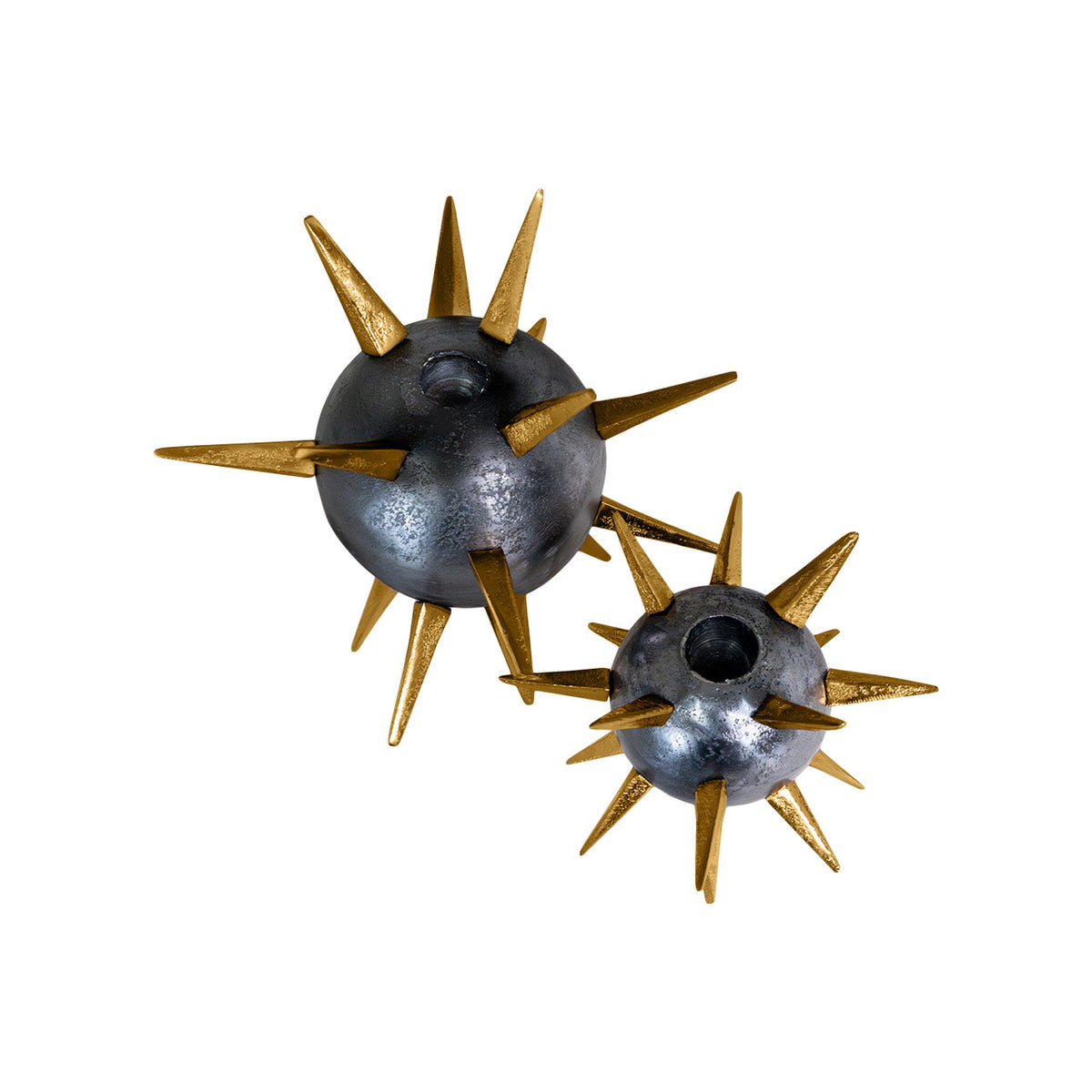 The Import Collection's Punk Candleholders feature metallic designs with multiple gold spikes. Displayed side by side on a white background, the bold gold spike candleholders come in two sizes, adding an edgy touch to any industrial decor.