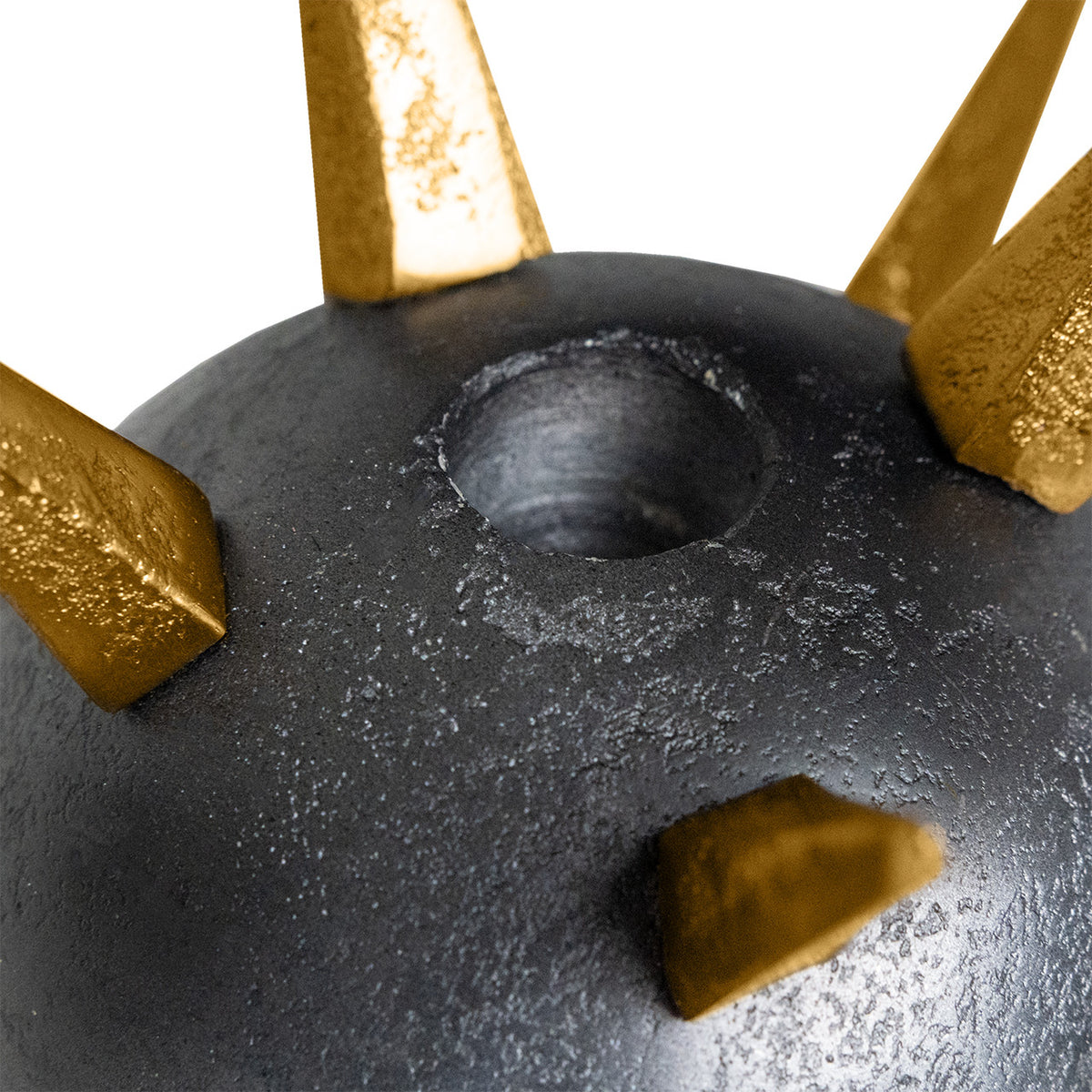 Close-up of the Punk Candleholder by The Import Collection, featuring dark gray and metallic gold spikes with a central circular hole, highlighting its bold industrial design against a white background.