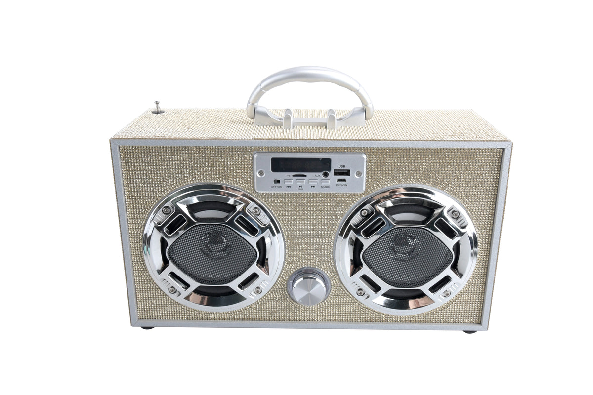 The Faire Gold Bling Wireless Boombox with FM Radio features a beige textured exterior, two large circular LED light-up speakers, a central control knob, and a silver handle, all set against a white background.