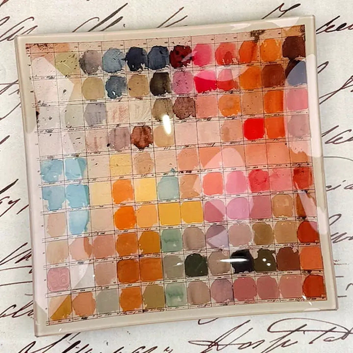 The Watercolor Artist's Palette Decoupage Glass Tray by Faire features a vintage square grid of vibrant watercolor swatches atop handwritten script—ideal inspiration for your next handmade project.