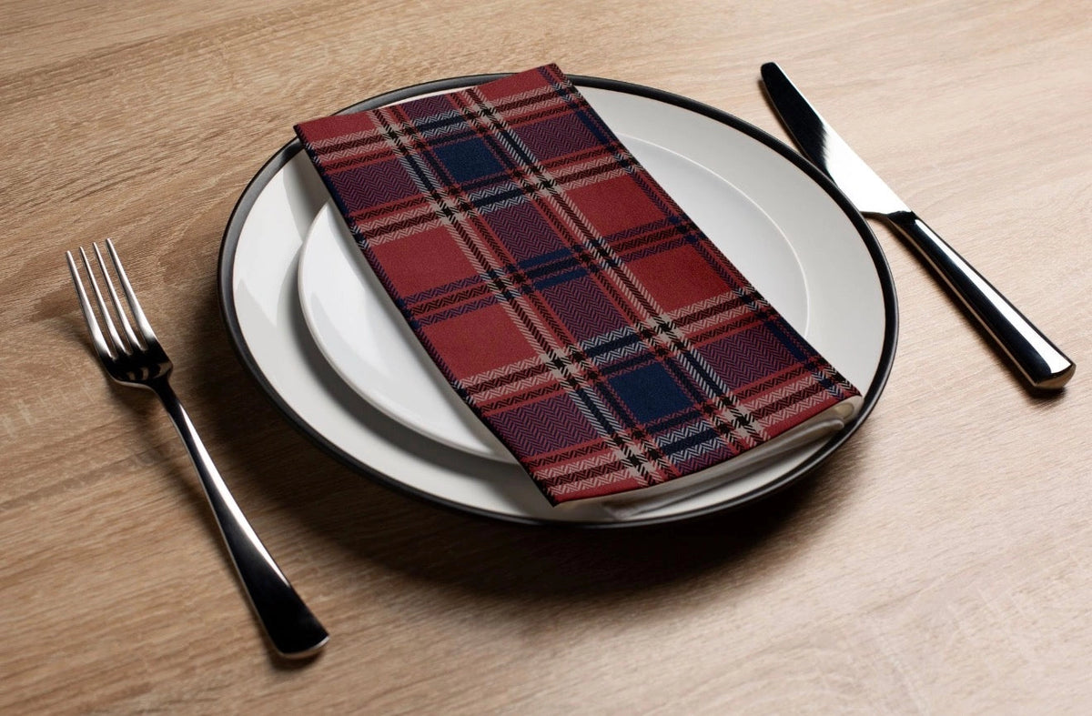 Faire Brick Plaid guest towel on a plate with cutlery, set on a wooden table at Bungalow Furniture & Accessories.
