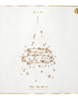 The Gold Sparkle Star Chandelier by Faire comes in a decorative box with a pajaki-inspired illustration of a hanging star chandelier, gold glitter stars, and “Gold Sparkle Star Chandelier” written in gold text, framed with a thin gold border.