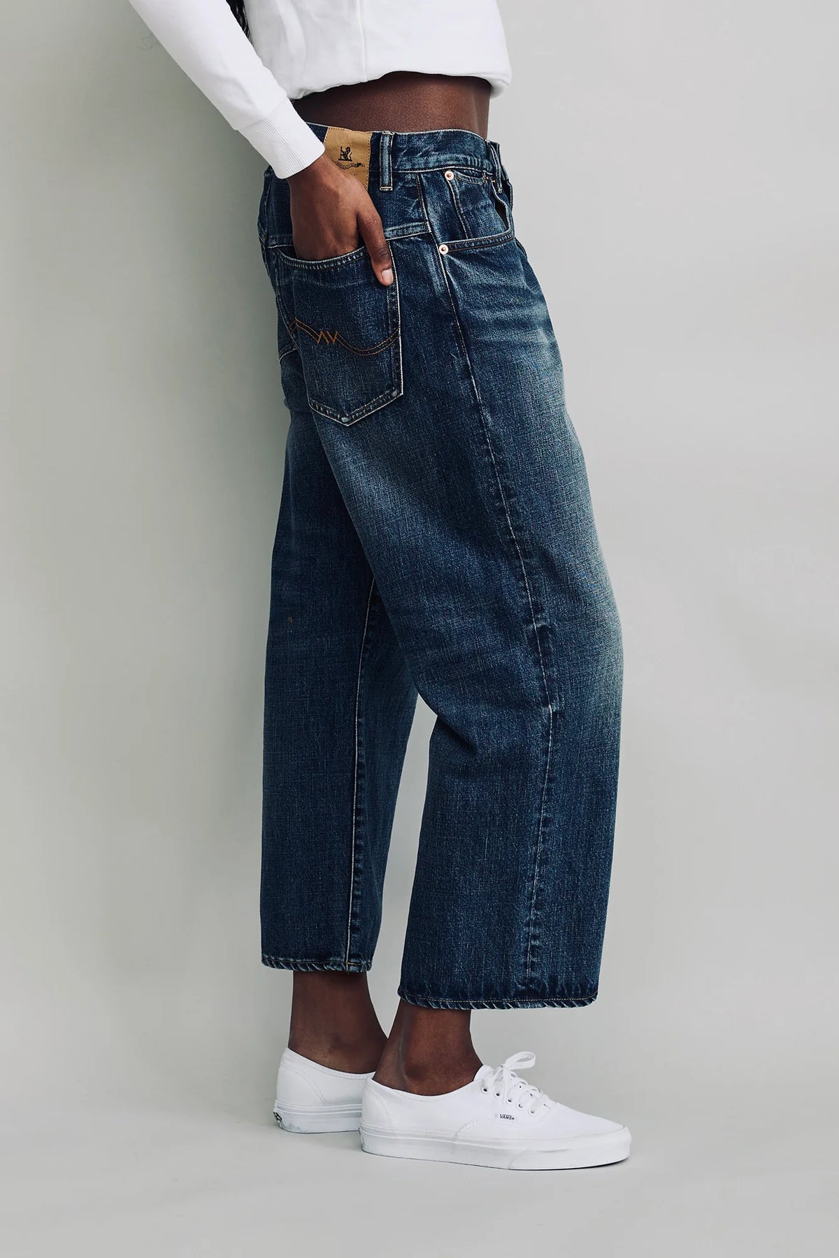 Denimist Haisley Slouch BF jeans in Sloane Indigo styled with white sneakers on a neutral background.