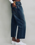 Denimist Haisley Slouch BF jeans in Sloane Indigo styled with white sneakers on a neutral background.