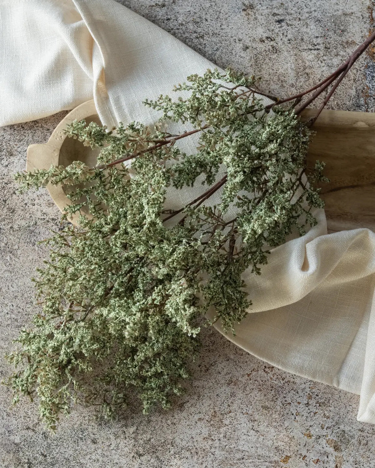 Silk and dried greenery spray in sage, 41 inches long by Faire, adds rustic charm to home decor.