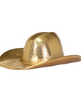 The Import Collection’s 44-230 Westin Hat is a shiny gold cowboy hat with a wide brim and western creased crown—ideal as a decorative accent or sculpture for unique western home decor. Shown on a white background.