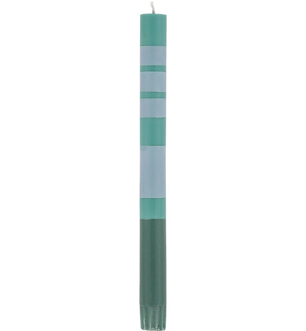 The Striped Beryl Green & Moonstone Candles S/2 by Faire feature tall, slender hand-poured candles with alternating blue and green bands, adding vibrant elegance to any table setting.