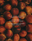 A stack of ripe peaches with text overlay: "Peach, apricot, nectarine..."—all in SWEET BOY 12 oz candle by Faire. Enjoy a non-toxic, clean-burning soy wax candle that captures fresh fruit fragrance notes.