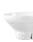 The Montes Doggett Catchall Bowl No 257 is a high-fired white ceramic bowl with a wide rim, narrow base, and small "MO" emblem. Microwave and dishwasher safe, it's photographed on a plain white background.