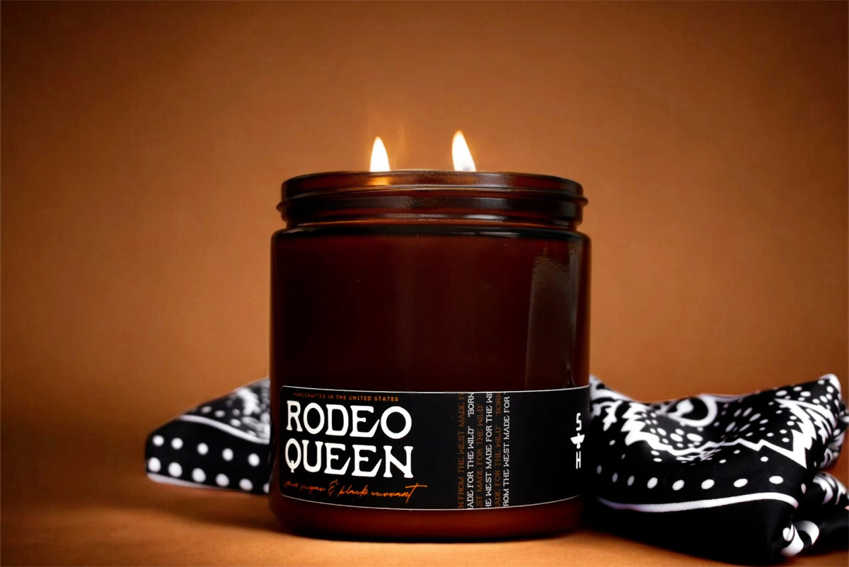 Brown soy coconut wax Faire Rodeo Queen Candle with two flames on a black and white bandana.