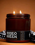 Brown soy coconut wax Faire Rodeo Queen Candle with two flames on a black and white bandana.