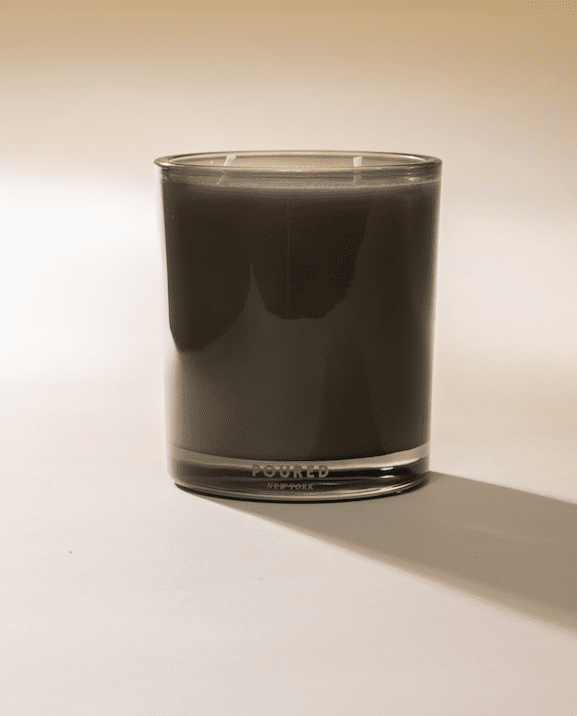 Black Faire Herbituals herbal candle in clear glass, subtle shadow on white surface, Bungalow Furniture &amp; Accessories.