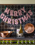 Merry Christmas puffy gingham fabric banner hanging above a kitchen stove by Bungalow Furniture & Accessories.