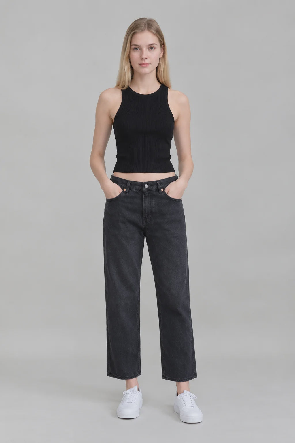 Denimist LUCY BF cropped jeans in light wash, styled with a black sleeveless top and white sneakers, gray background.
