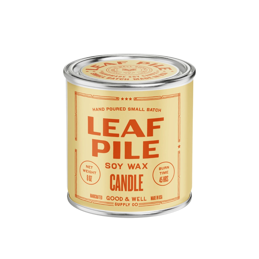 Yellow Faire Leaf Pile Soy Candle, 8oz with orange label; autumn scent and 45-hour burn time.