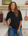 Frank & Eileen Perry NYC Crew Tee in white styled with blue jeans in a bright, modern kitchen setting.