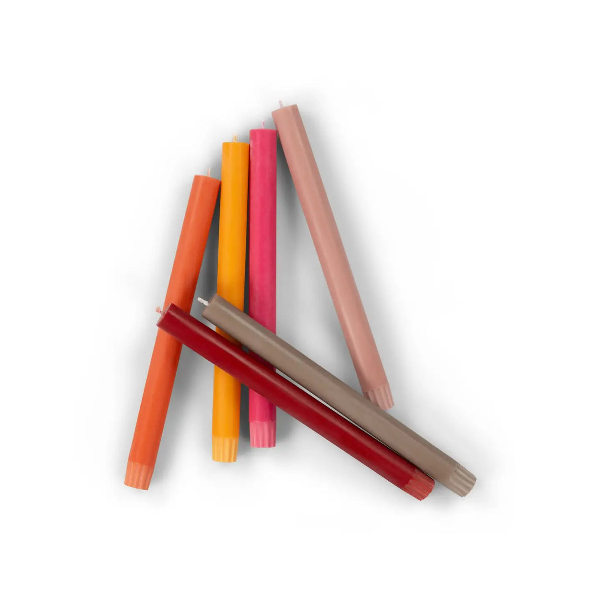 The Faire Warm Colours Dinner Candles S/2 are hand-poured in vibrant shades and displayed in a loose, overlapping cluster on a white background.