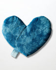 The Faire Heart Eye Pillow is a soft, blue, heart-shaped cotton pillow with a side loop tag, shown on a plain white background—ideal for soothing anxiety relief.