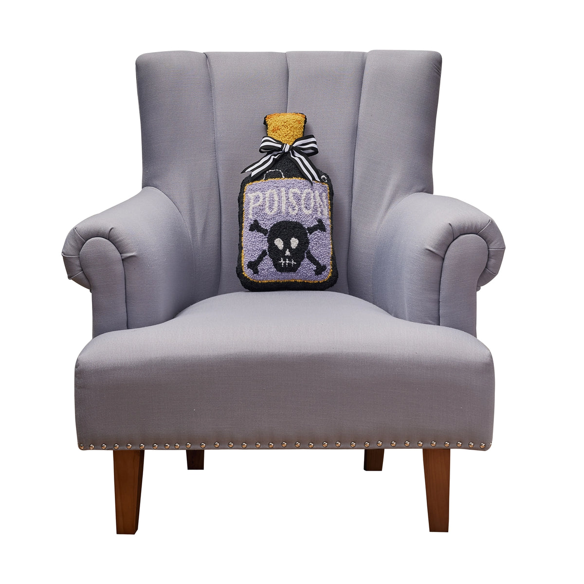 Faire Poison Bottle Hook Pillow by Bungalow Furniture, with a quirky Halloween design on a gray armchair.