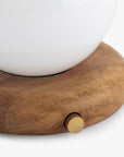 A close-up of the Faire Valencia Portable Light—a round wooden base lamp with a gold knob and white top—set against a plain background.