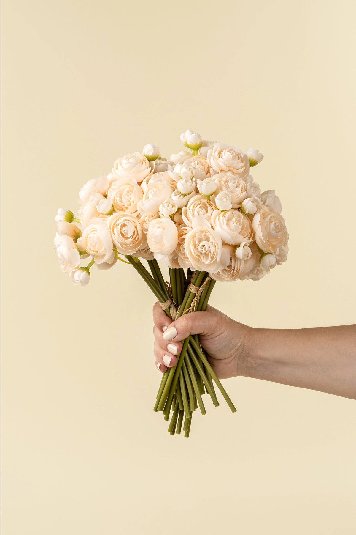 Lifelike cream Ranunculus bouquet held by hand, Bungalow Furniture &amp; Accessories.