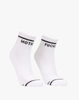 The Baby Steps Ankle socks by Mother feature black and white styling with black trim. "MOTHER" appears on the left sock and "FUCKER" on the right, giving a bold edge to classic tube socks.