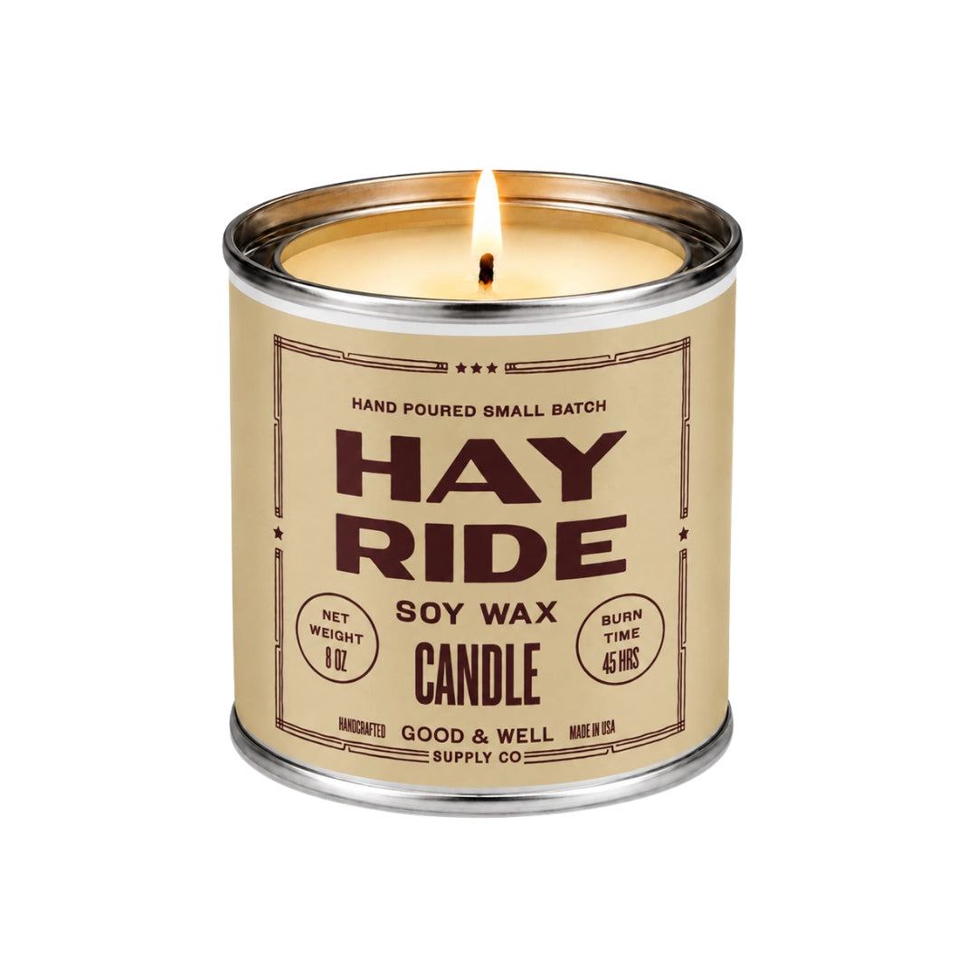 Tin soy candle with Hay Ride label from Faire featuring cedarwood scent, burn time, and weight details.