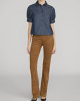 FRAME Poise Top lightweight denim shirt with covered buttons and pointed collar against gray background.