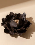The Faire Ceramic Anemone Incense Holder features sculpted, layered petals in dark brown with a textured center and a rustic glaze, capturing traditional Chinese charm as it rests on a light beige surface casting a soft shadow.