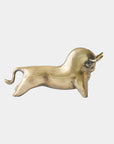 Antique brass bull sculpture with curved horns and raised tail by Global Views, Sampson collection on white background.